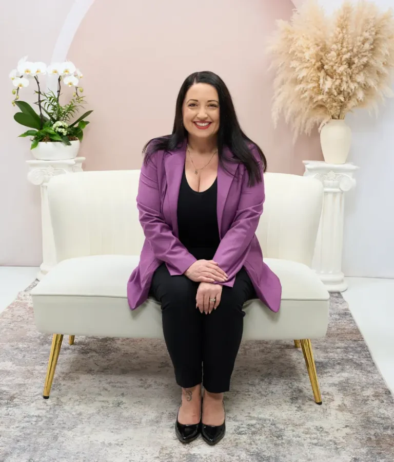 Psychic medium Courtney Dawson seated in her studio