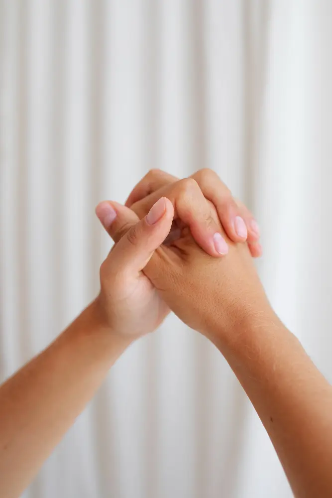 Hands held together during a supportive mentorship session