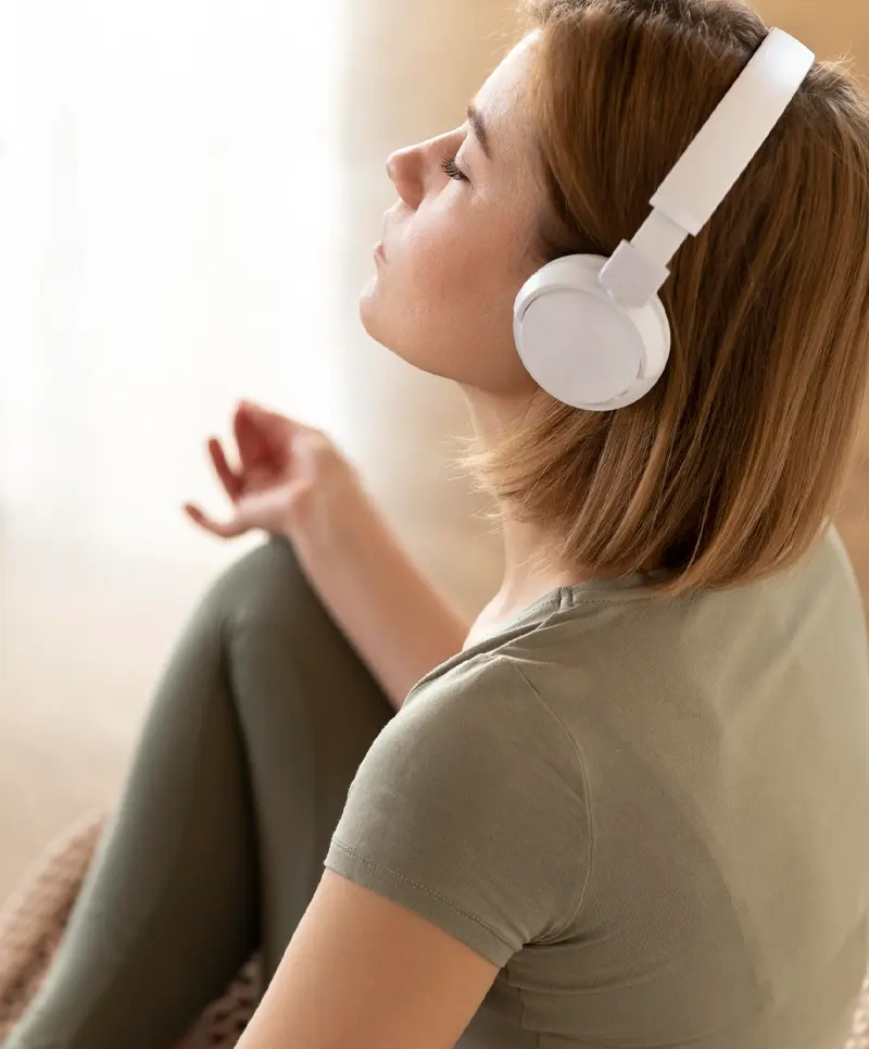 Woman wearing headphones during a mindful reset