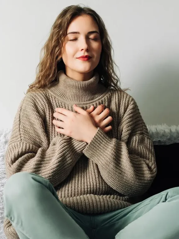 Woman practicing mindfulness with her hand over her heart